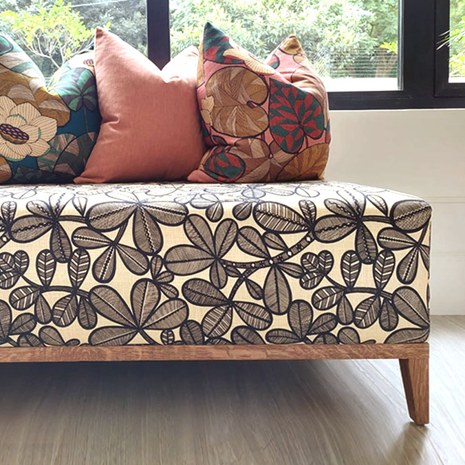 Bespoke residential interior design by edge.ids featuring a custom couch and designer cushions in a modern living space.