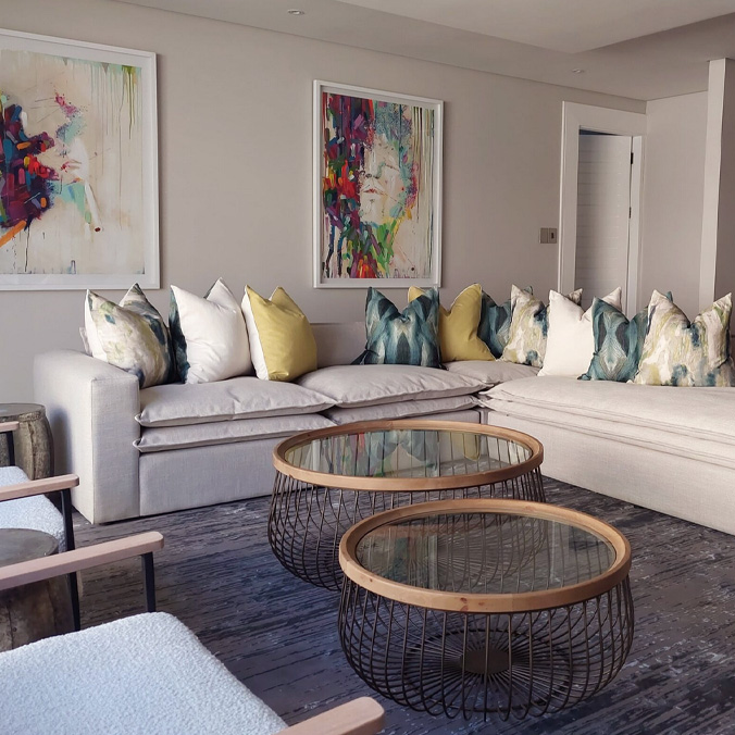 Luxury **custom cushions** in curated textures and colors paired with a large neutral sectional sofa featuring **bespoke upholstery** by edge.ids Johannesburg.