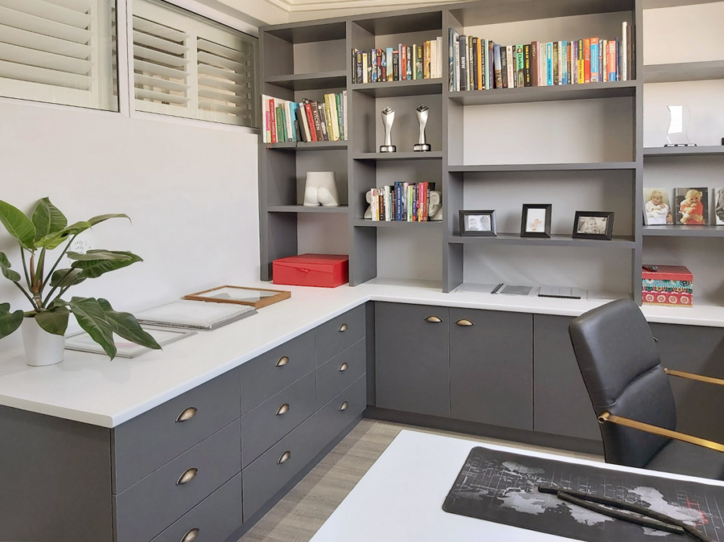Custom built-in home office cabinetry with grey shelving and white work surfaces at Waterfall Country Estate.