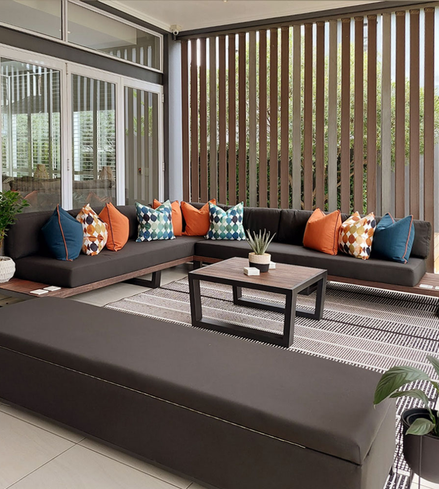 Custom steel and wood patio furniture set with bespoke scatter cushions by Edge.IDS at Waterfall Country Estate.
